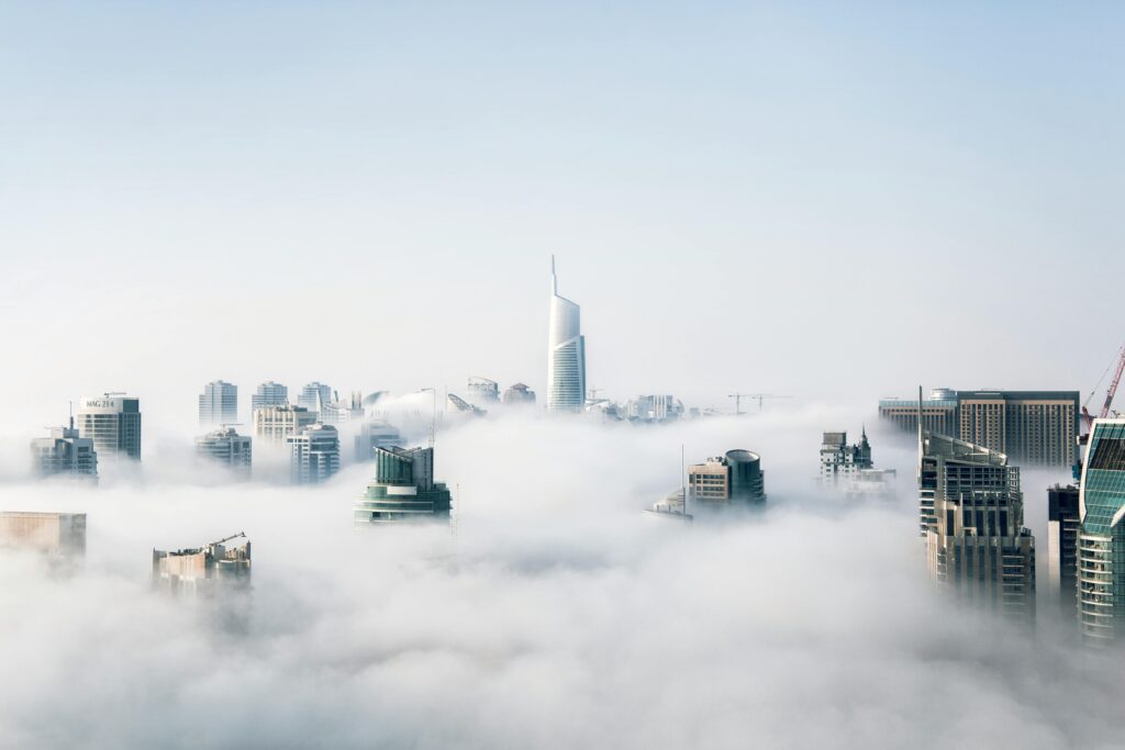pexels-photo-325185-325185 A stunning view of Dubai skyscrapers emerging through a blanket of fog, showcasing modern architecture.